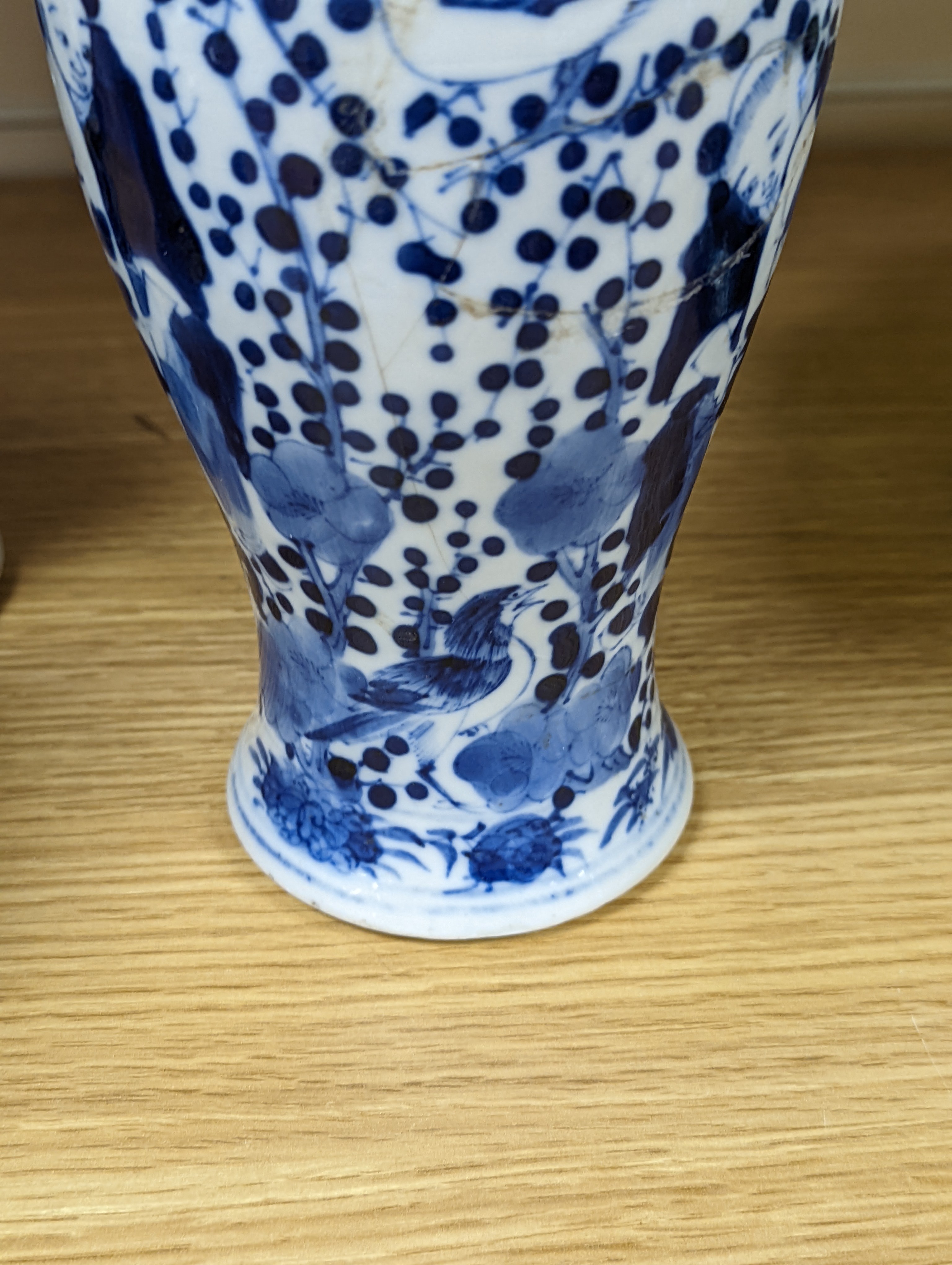 A pair of 19th century Chinese blue and white vases, a prunus vase and cover and a similar jar (4), pair of vases 24 cms high.